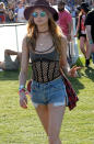 The wide-brimmed hat, round sunnies, jean shorts, and layered neclaces are all Coachella staples, but Behati Prinsloo also brought some Victoria's Secret to the festival with her with a sheer cage tank.