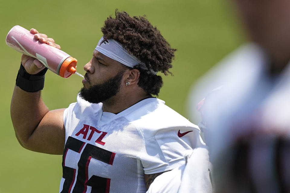 Atlanta Falcons offensive lineman Jovaughn Gwyn (56) hydrates during the NFL football team's rookie minicamp, Saturday, May 13, 2023, in Flowery Branch, Ga. (AP Photo/Brynn Anderson)