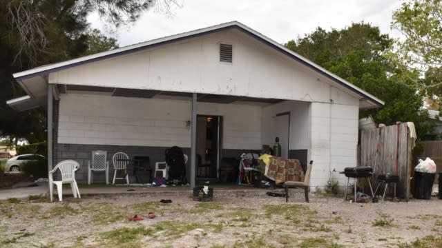 The house where a woman holding her 11-month-old son in a baby carrier was fatally shot by her 14-year-old brother.