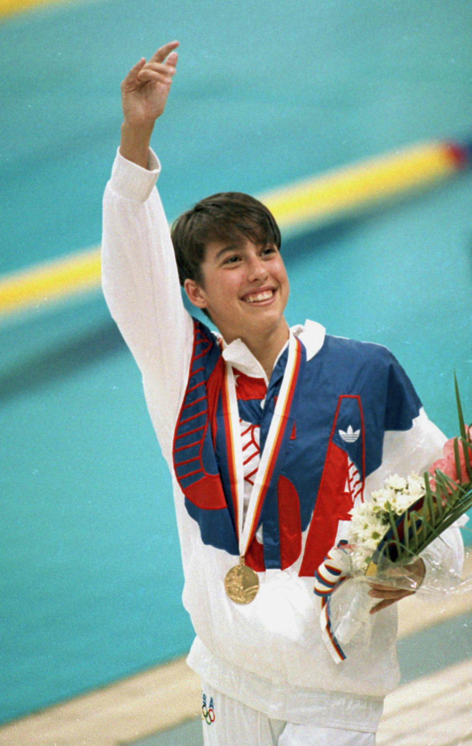 American Janet Evans, of Placentia, Calif., waves to the crowd after her gold medal victory in the Olympic women's 400-meter freestyle in Seoul, Korea, Sept. 22, 1988. Evan's time of 4:03:85 seconds broke her old world record of 4:05:45 seconds she set the previous year. (AP Photo/Ronald Kennedy)