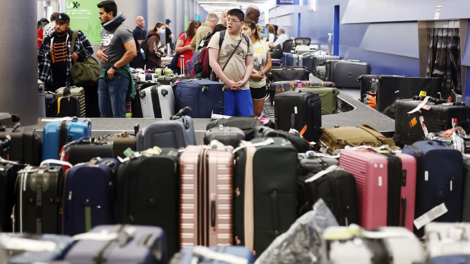 Travelers wait for their bags amid rows of unclaimed luggage at the United Airlines baggage claim area at Los Angeles International Airport (LAX) on June 29, 2023 in Los Angeles, California. - Mario Tama/Getty Images