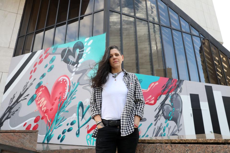 Muralist Katie Reidy of Ossining stands beside the mural she was commissioned to paint at the former Galleria mall site in White Plains Dec. 19, 2023. Reidy was a tenant at the mall where she ran a gallery.