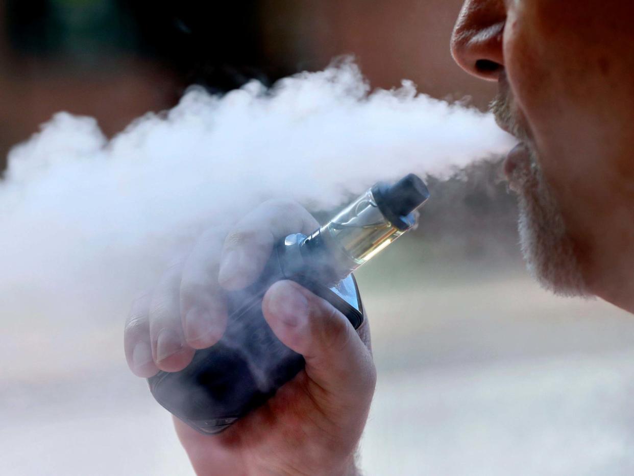 A man exhales a heavy cloud of smoke while enjoying an e-cigarette in Portland, US: AP