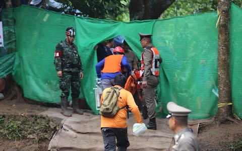 Rescuers work near the cave where 12 young soccer team members and their coach were trapped in Chiang Rai, - Credit: Xinhua/Barcroft Media