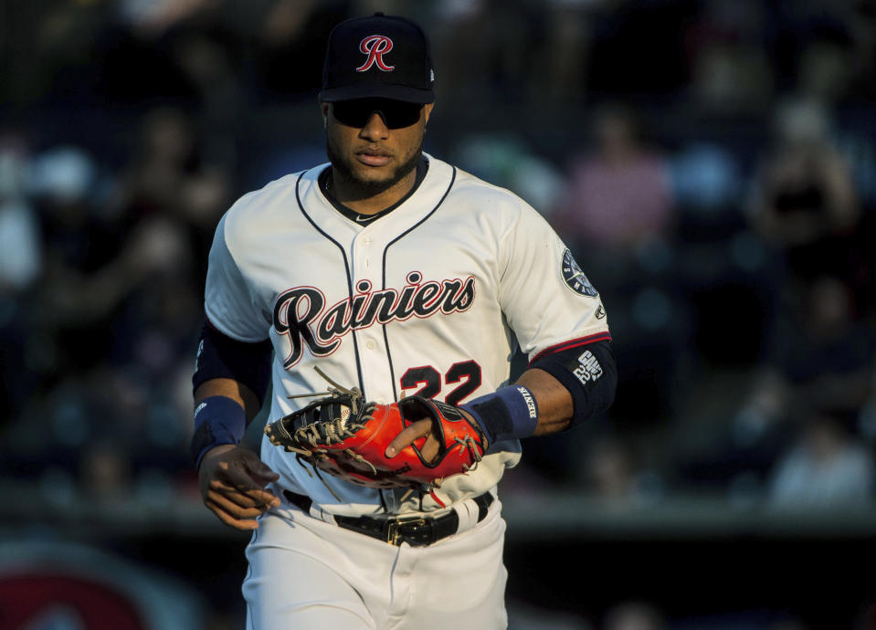 Robinson Cano jogs onto the field during his first rehab start with the Tacoma Rainiers at Cheney Stadium in Tacoma, Wash., Monday, Aug. 6, 2018. Cano is beginning a rehab assignment with the Seattle Mariners' Triple-A affiliate as he prepares for his return from his 80-game suspension for violating baseball's joint drug agreement. (Joshua Bessex/The Tacoma News Tribune via AP)