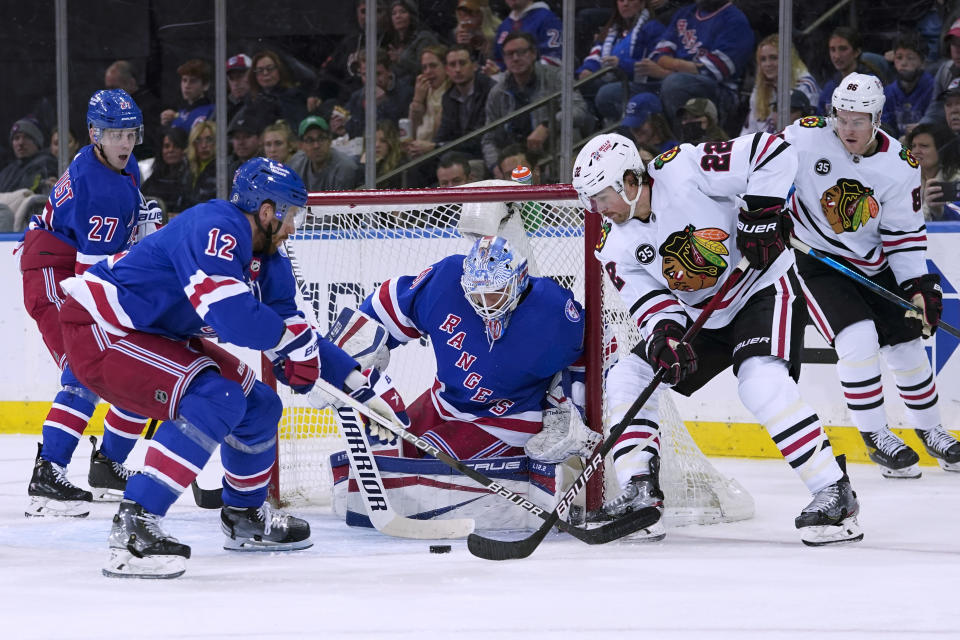 New York Rangers goaltender Alexandar Georgiev (40) and defenseman Patrik Nemeth (12) defend against Chicago Blackhawks center Ryan Carpenter (22) during the second period of an NHL hockey game Saturday, Dec. 4, 2021, at Madison Square Garden in New York. (AP Photo/Mary Altaffer)