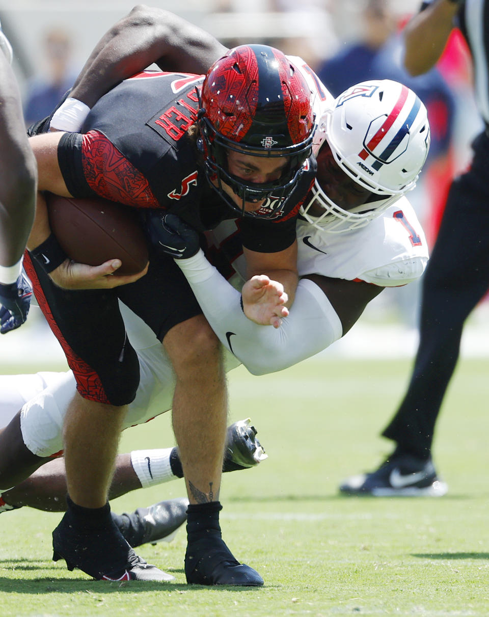 San Diego State's Braxton Burmeister, left, is tackled by Arizona's Jalen Harris in the first quarter of an NCAA college football game Saturday, Sept. 3, 2022, in San Diego. (K.C. Alfred/The San Diego Union-Tribune via AP)