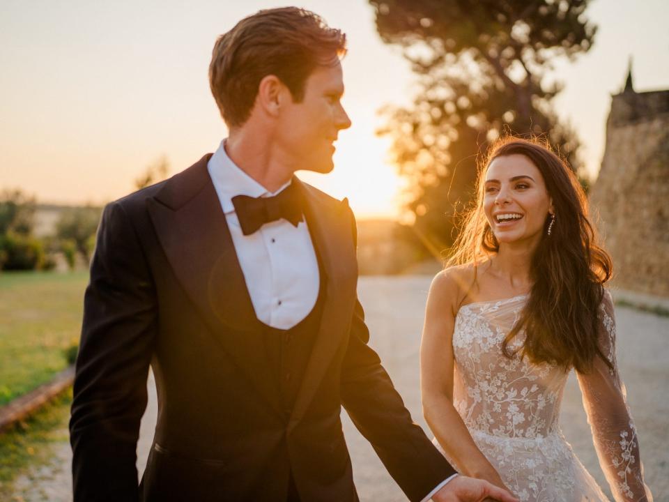 A groom and bride look at each other and smile.