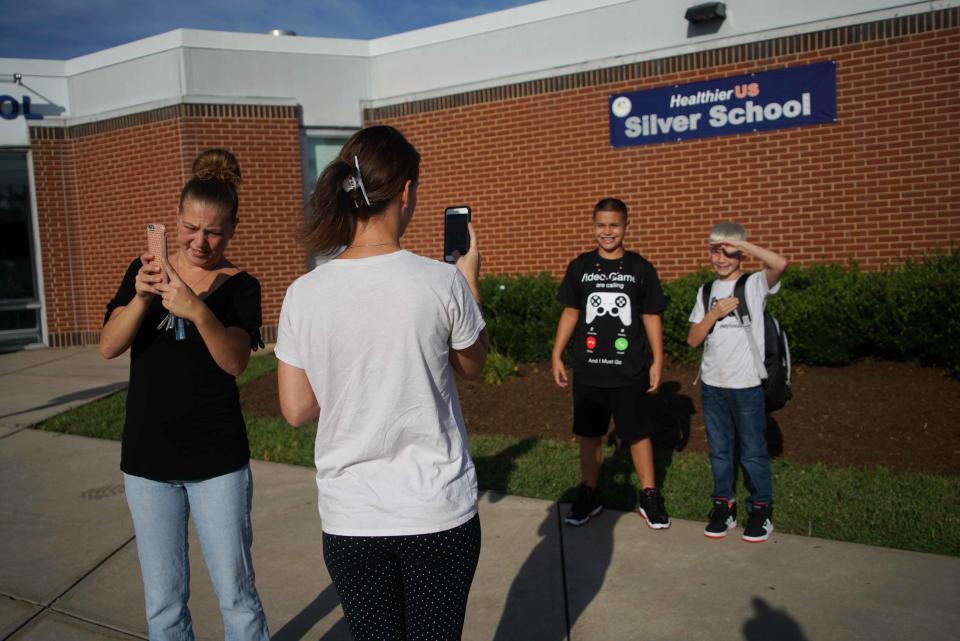 Parents of students at Marbrook Elementary School grab photographs of their children on the first day of school in 2019.