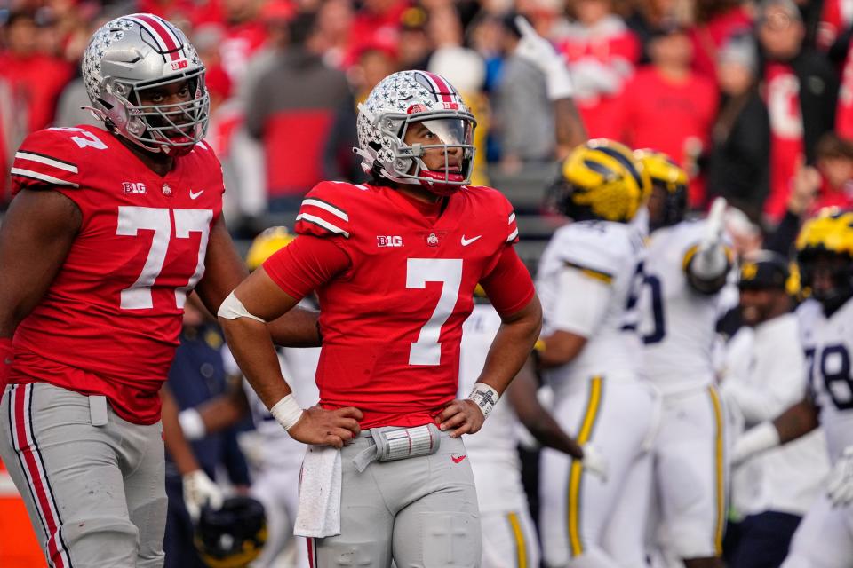 Nov 26, 2022; Columbus, Ohio, USA;  Ohio State Buckeyes offensive lineman Paris Johnson Jr. (77) consoles quarterback C.J. Stroud (7) after he gave up an interception to Michigan Wolverines linebacker Taylor Upshaw (91) during the second half of the NCAA football game at Ohio Stadium. Michigan won 45-23. Mandatory Credit: Adam Cairns-The Columbus Dispatch