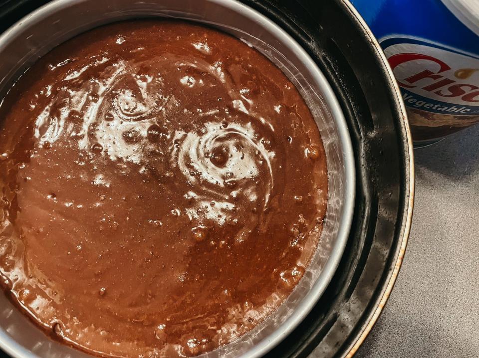 round metal pan of brownie batter in an air fryer