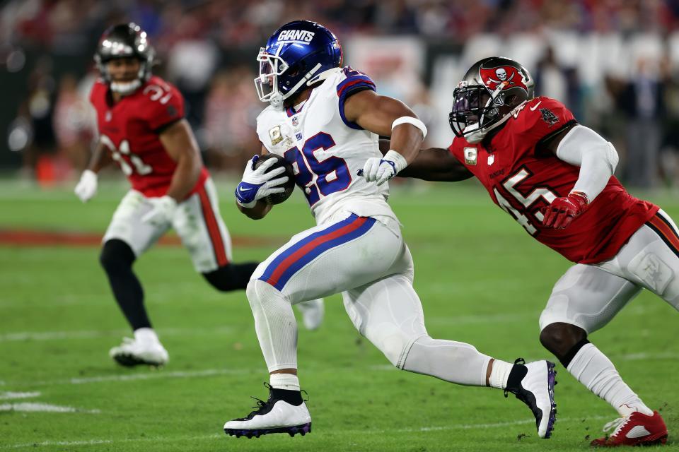 New York Giants running back Saquon Barkley runs away from Tampa Bay Buccaneers inside linebacker Devin White during a game  Monday in Tampa, Fla. Barkley should have a better fantasy game against the Philadelphia Eagles in Week 12.