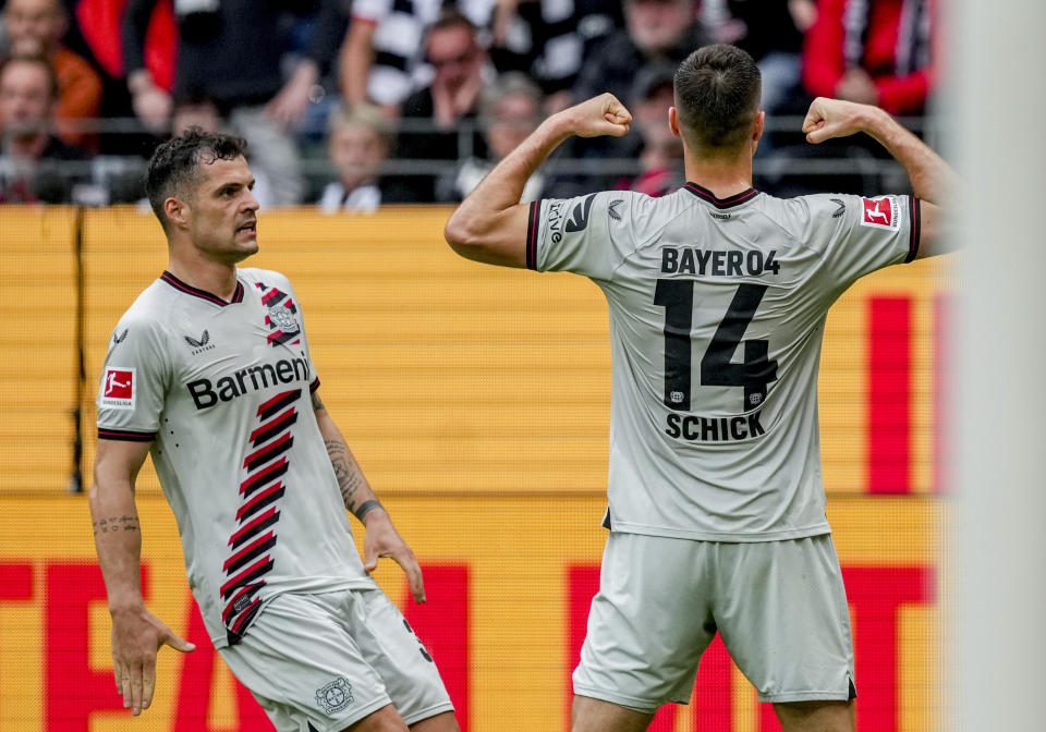 Leverkusen's Patrik Schick, right, celebrates his side's second goal during the German Bundesliga Soccer match between Eintracht Frankfurt and Bayer Leverkusen in Frankfurt, Germany, Sunday, May 5, 2024. Left Leverkusen's Granit Xhaka who scored the first goal. (AP Photo/Michael Probst)