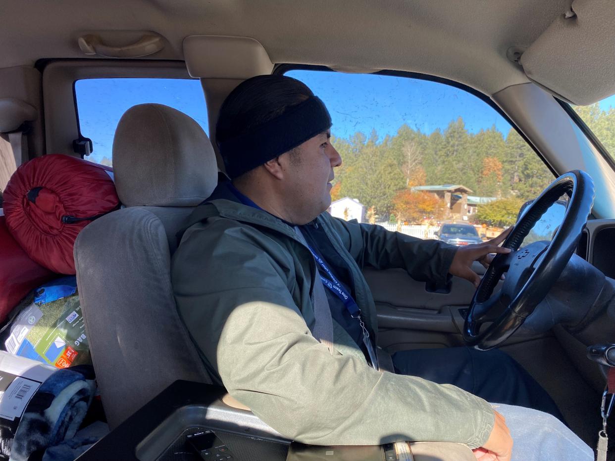Dwight Manuel drives through northern Arizona on Oct. 28, 2022, looking for people experiencing homelessness and in need of assistance.