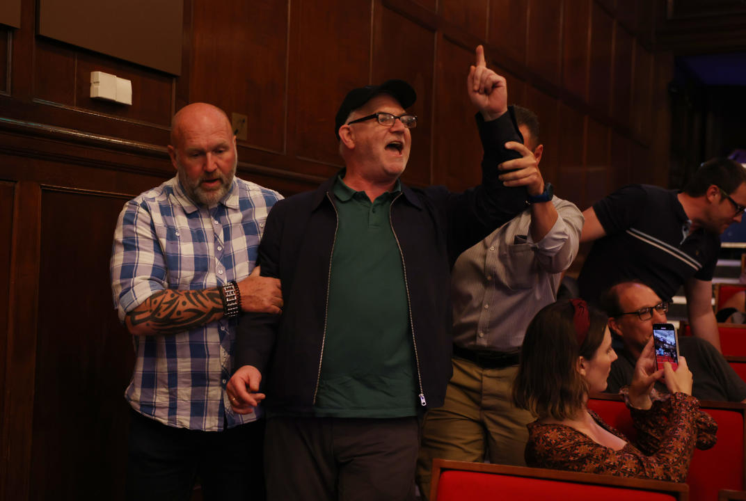 LONDON, ENGLAND - JULY 5: A heckler is removed by security during a Reform UK press conference presenting their programme for the upcoming Parliament, on July 5, 2024 in London, England. Reform UK won four seats at the 2024 general election including Nigel Farage's seat of Clacton and Harwich. The party benefitted from a significant fall in the Conservative vote that saw them retain only 121 seats delivering a landslide victory to the Labour Party who took 412 seats. (Photo by Dan Kitwood/Getty Images)