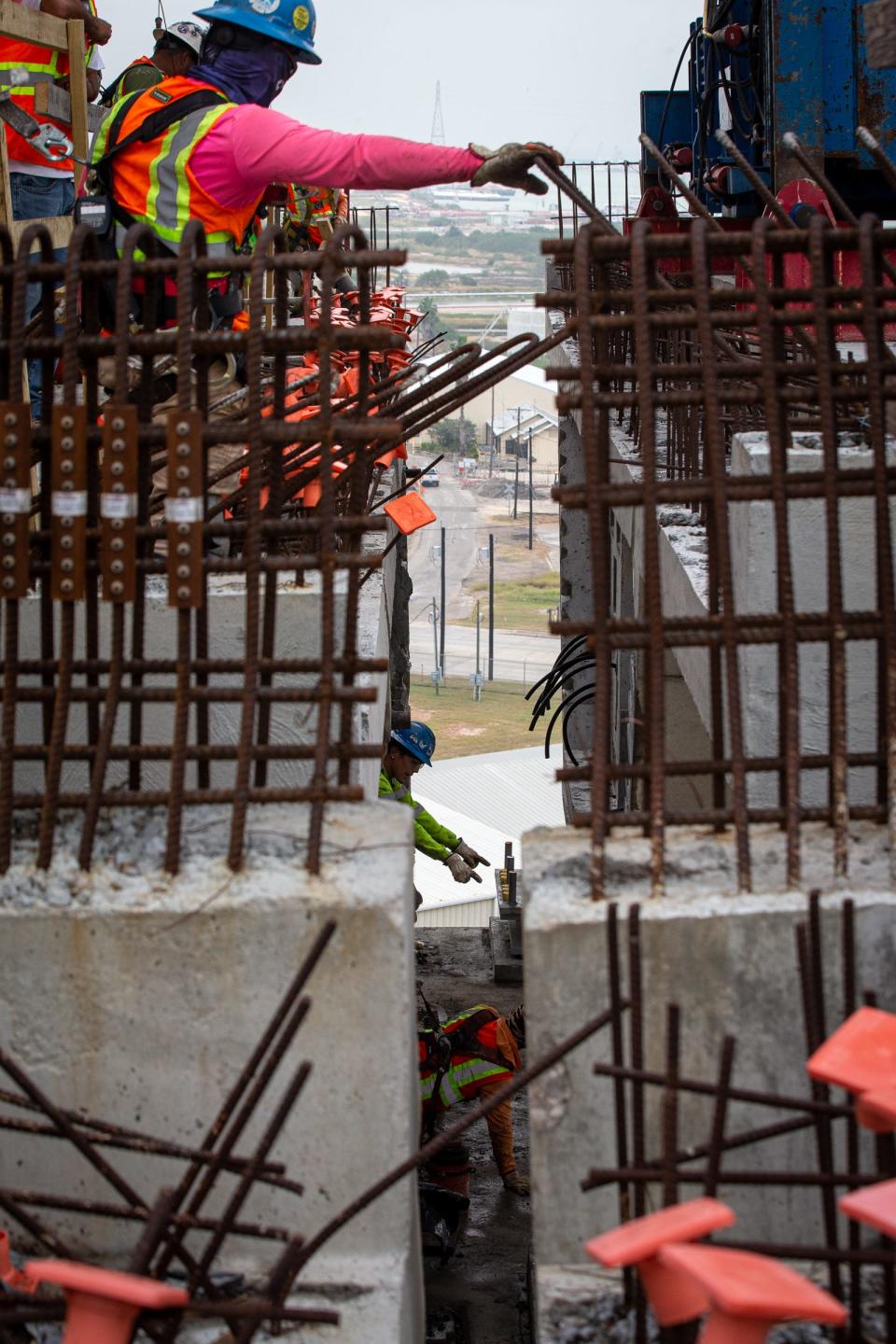 Construction workers join approach segments together with a crane on the new Harbor Bridge on Oct. 28, 2022, in Corpus Christi, Texas.