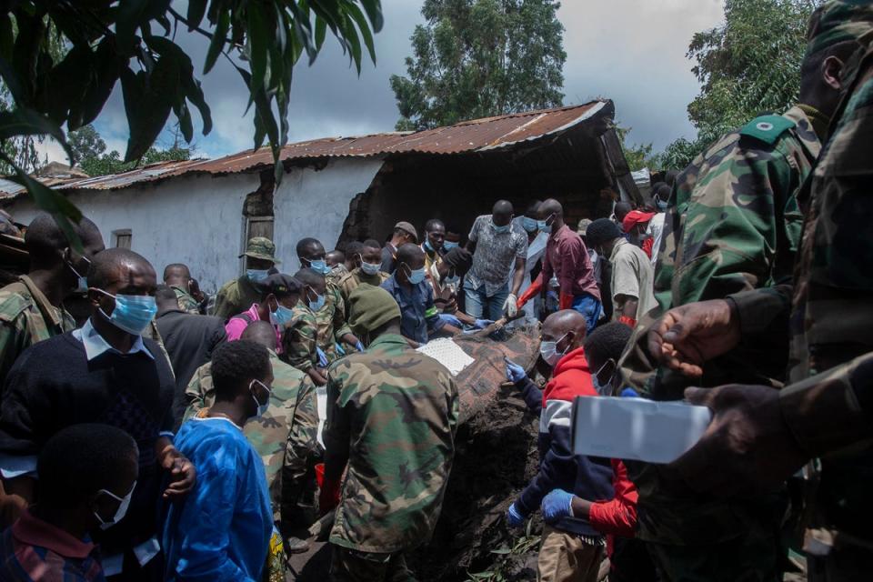 Malawi Defence Force soldiers recover a body of a landslip victim on Thursday in the wake of Cyclone Freddy (AFP via Getty Images)