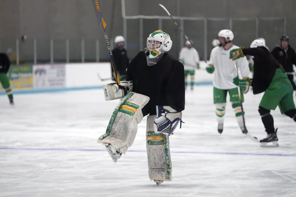 Evan Smolik skates during hockey practice Wednesday, Nov. 29, 2023, in Edina, Minn. When Evan was 14, a teammate's skate struck his neck and his jugular vein, but the neck guard he was wearing prevented the skate from cutting his carotid artery and helped save his life. (AP Photo/Abbie Parr)