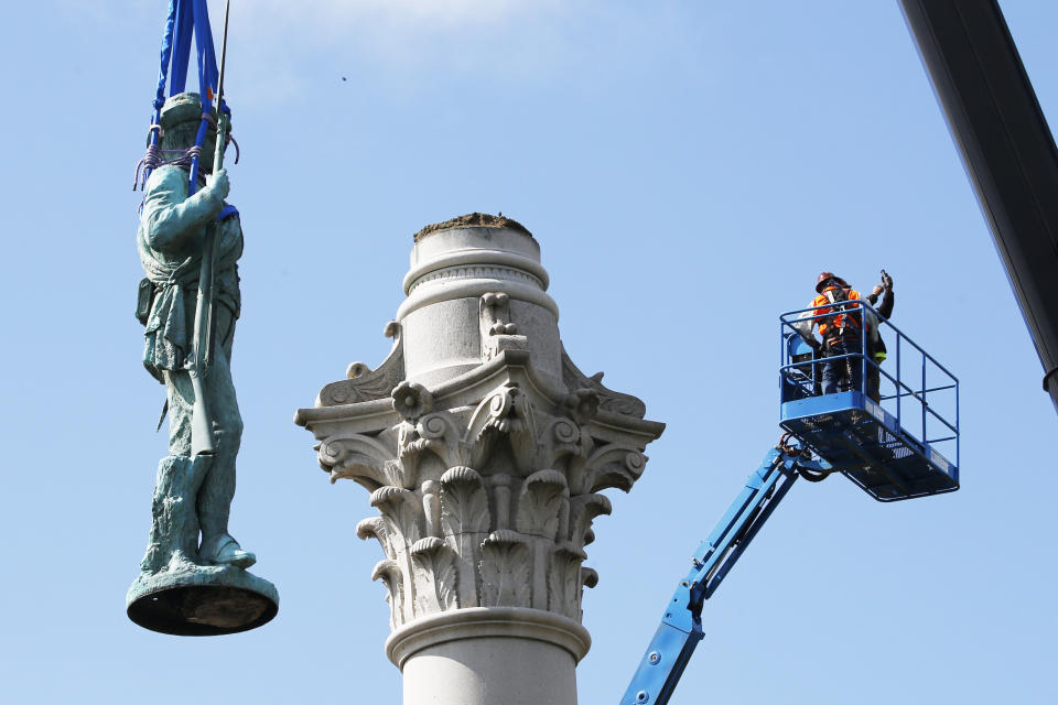 FILE - Crews remove the Confederate Soldiers & Sailors Monument in Libby Hill Park in Richmond, Va., on July 8, 2020. At least 63 Confederate statues, monuments or markers have been removed from public land across the country since George Floyd’s death on May 25, making 2020 one of the busiest years yet for removals, according to an Associated Press tally. (AP Photo/Steve Helber, File)