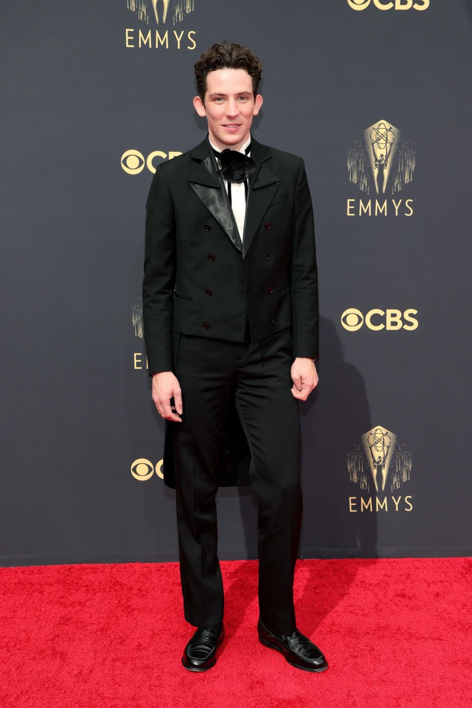 Josh O'Connor wears a black suit on the Emmys red carpet.