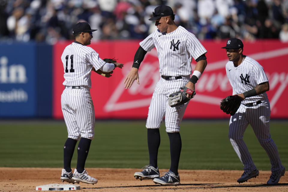 New York Yankees' Anthony Volpe, left, Aaron Judge, center, and Gleyber Torres celebrate after a baseball game against the San Francisco Giants at Yankee Stadium Sunday, April 2, 2023, in New York. The Yankees defeated the Giants 6-0. (AP Photo/Seth Wenig)