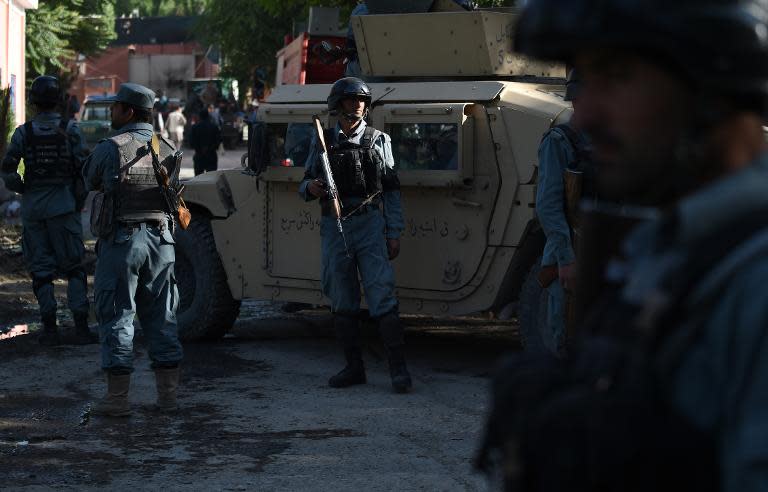 Afghan security forces keep watch outside the gates of the Heetal Hotel in Kabul on May 27, 2015 after an attack by the Taliban was repelled