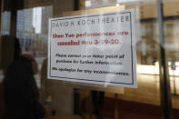 A sign on the door of the David H. Koch Theater at Lincoln Center Thursday, March 12, 2020, announces the cancellation of Shen Yun performances through March 29, in New York. Nearly all of Lincoln Center's performance spaces closed their doors after New York Gov. Andrew Cuomo announced a temporary statewide ban on gatherings of more than 500 people. For most people the new coronavirus causes only mild or moderate symptoms, such as fever and cough. For some, especially older adults and people with existing health problems, it can cause more severe illness including pneumonia. (AP Photo/Kathy Willens)