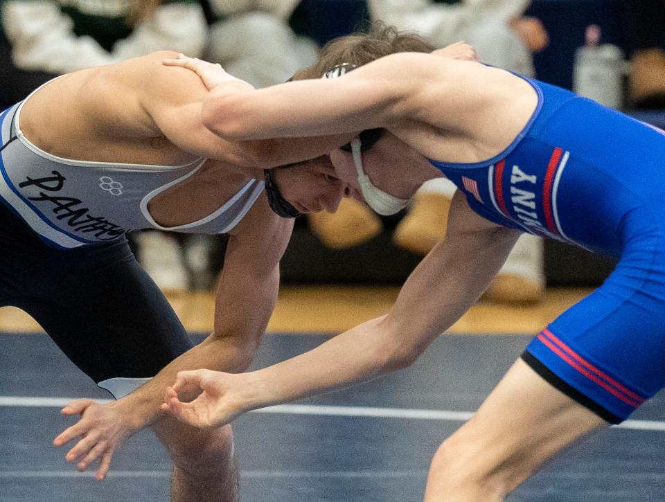 Quakertown's Mason Ziegler (left), shown here facing Neshaminy's Nate Pokalsky in the quarterfinals of the PIAA District One East Class 3A tournament, won his fourth district title Saturday at 121 pounds.
