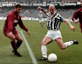 FILE - Former Italian national soccer team striker Gianluca Vialli, right, kicks the ball under the gaze of Torino's defender Sean Sogliano during their Italian Serie A soccer match at the Delle Alpi stadium in Turin, Italy, Saturday, April 6, 1996. Gianluca Vialli, the former Italy striker who helped both Sampdoria and Juventus win Serie A and European trophies before becoming a player-manager at Chelsea, has died on Friday, Jan. 6, 2023. He was 58. (AP Photo/Mauro Pilone, File)