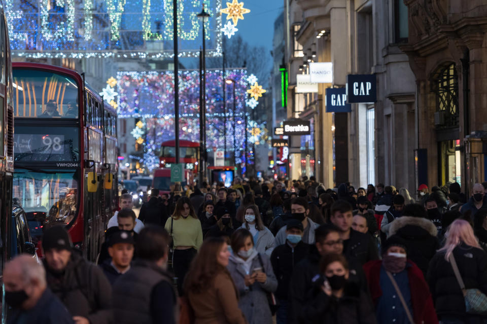 Crowds of shoppers and commuters walk along Oxford Street ahead of introduction of tougher coronavirus restrictions in the run up to Christmas, on 15 December, 2020 in London, England. From tomorrow, Greater London, as well as parts of Essex and Hertfordshire, will move into Tier 3 coronavirus restrictions resulting in closing of pubs, bars, restaurants, hotels and indoor entertainment venues such as theatres and cinemas, as the infection rates are well above the national average and continue to rise. (Photo by WIktor Szymanowicz/NurPhoto via Getty Images)