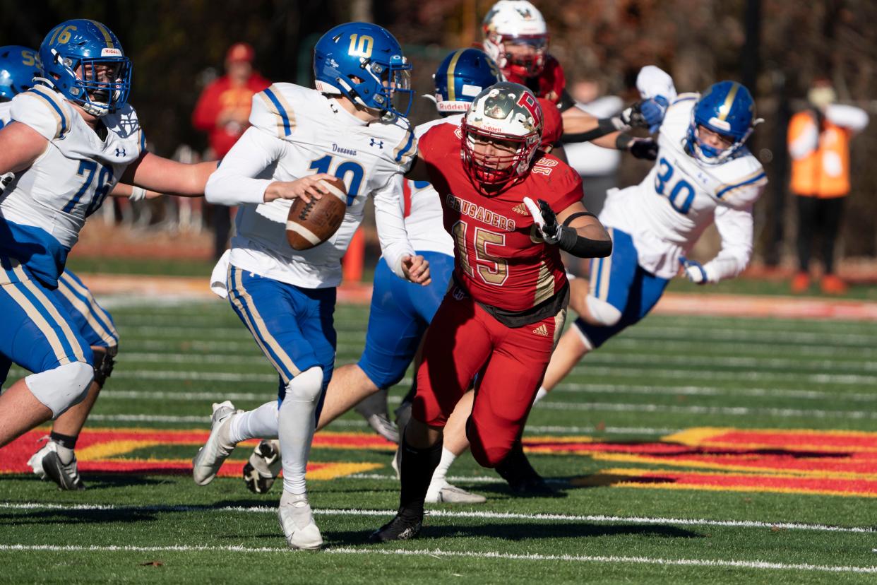 Nov 18, 2023; Oradell, NJ, USA; Donovan Catholic football at Bergen Catholic in a State, Non-Public A, semifinal game. DC #10 QB Todd Lambertson looks to pass as BC #15 Anthony Morales tries to make the tackle.
