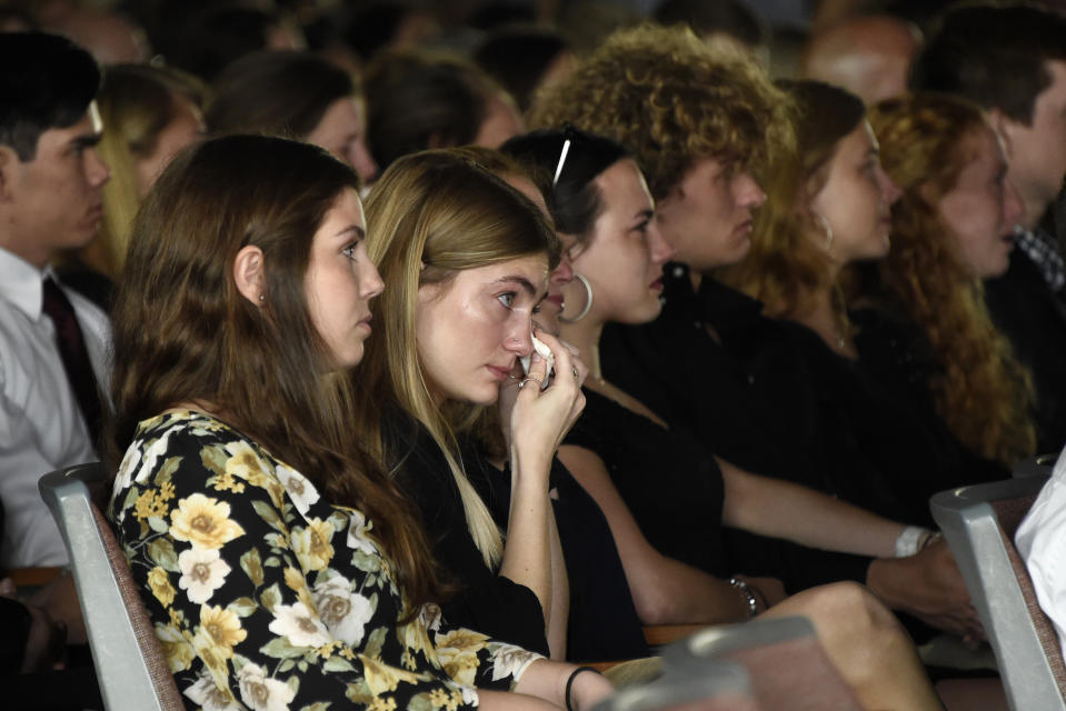 A mourner wipes a tear from her eye during the memorial service for Riley Howell in Lake Junaluska, N.C., Sunday, May 5, 2019. Family, hundreds of friends and a military honor guard on Sunday remembered Howell, a North Carolina college student credited with saving classmates by rushing a gunman firing inside their lecture hall. (AP Photo/Kathy Kmonicek)