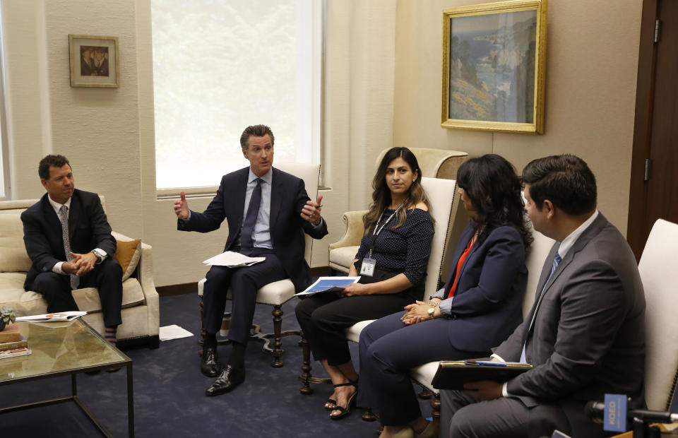 In this photo taken June 4, 2019, Gov. Gavin Newsom meets with a group of small business owners and government officials to discuss tax relief at his Capitol office in Sacramento, Calif. Lawmakers approved the state budget, Thursday, June 13, 2019, that includes an expansion of the state's earned income tax credit. Newsom wants to pay for it by adopting some of President Donald Trump's 2017 tax overhaul, but Assembly Democrats are cautious about this idea. (AP Photo/Rich Pedroncelli)