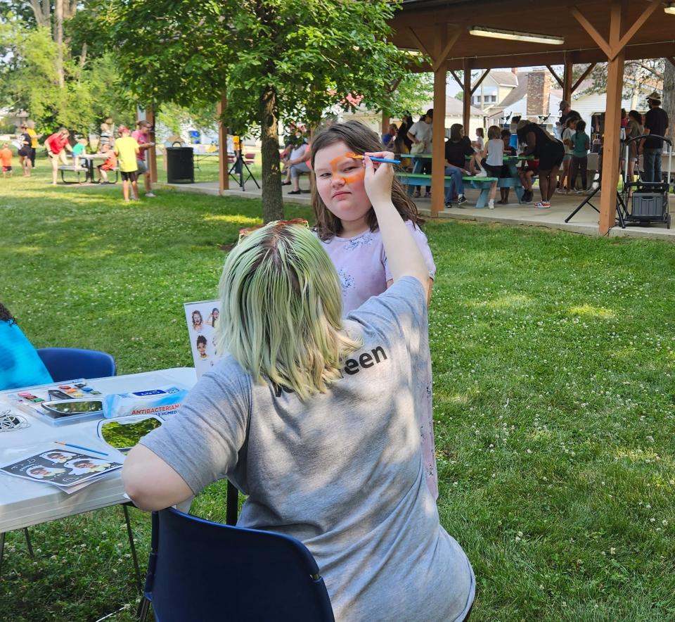 Cassie Seymor gets her face painted during the Chillicothe & Ross County Public Library's kickoff event for the Bookworm summer reading program.