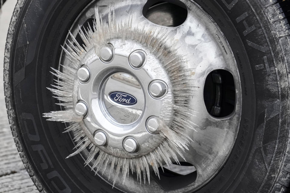 Ice forms on a truck's wheel as temperatures dropped below freezing, Monday, Jan. 15, 2024, in Conroe, Texas. (Brett Coomer/Houston Chronicle via AP)