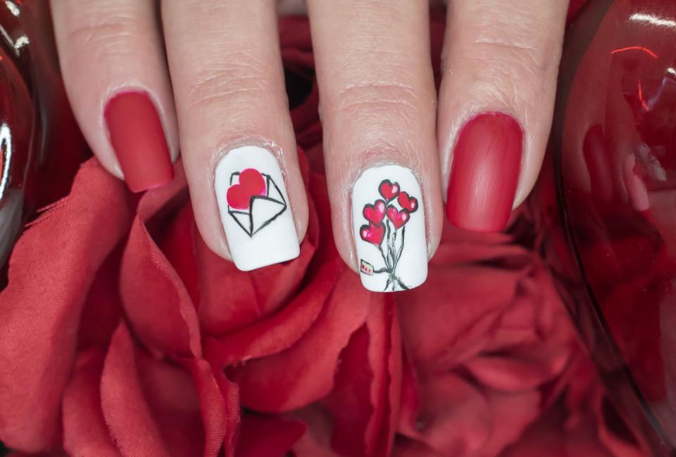 <p>This fun manicure is extra festive with an illustrated love letter and heart-shaped balloons.</p>