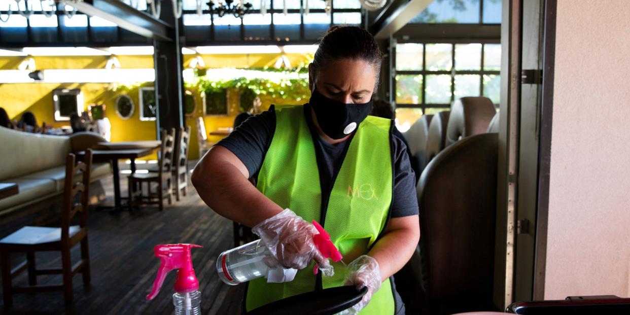FILE PHOTO: An employee routinely sanitizes server trays at a reopened restaurant after restrictions to prevent the spread of the coronavirus disease (COVID-19) are eased in Bloomfield Hills, Michigan, U.S., June 8, 2020.  REUTERS/Emily Elconin/File Photo