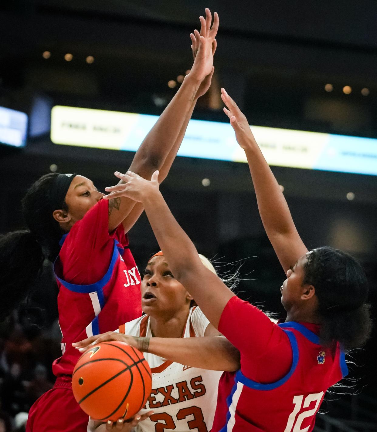 Texas Longhorns forward Aaliyah Moore (23) drives through Kansas Jayhawks defense in the first half of the Longhorns' game against the Kansas Jayhawks at the Moody Center in Austin, Jan 16, 2024. Texas won the game 91-56.