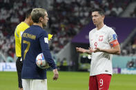 Poland's Robert Lewandowski, right, gestures as France's Antoine Griezmann holds the ball during the World Cup round of 16 soccer match between France and Poland, at the Al Thumama Stadium in Doha, Qatar, Sunday, Dec. 4, 2022. (AP Photo/Ricardo Mazalan)