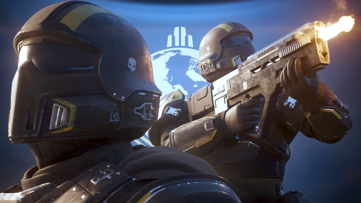  A heroic-looking Helldiver from Helldivers 2 stands proud in front of a flag, while a fellow soldier unloads a gun in stylish slow-mo in the background. 