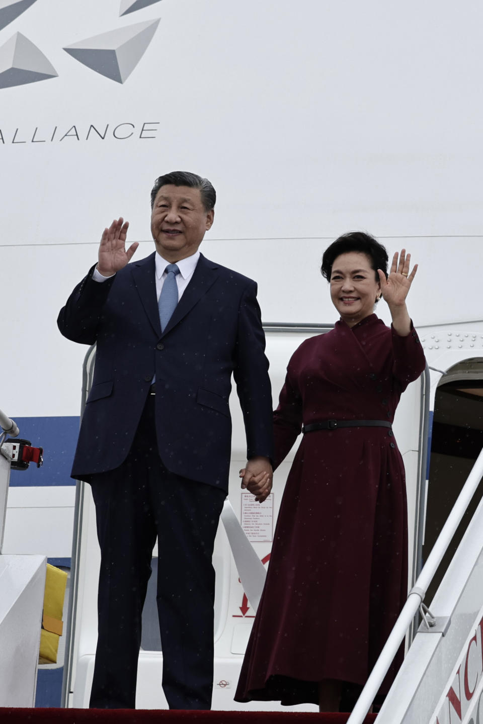 Chinese President Xi Jinping and his wife Peng Liyuan wave as they arrive at Orly airport, south of Paris, Sunday, May 5, 2024. Chinese President Xi Jinping kicked off a three-country trip to Europe on Sunday with the continent divided over how to deal with Beijing's growing power and the U.S.-China rivalry. (Stephane de Sakutin, Pool via AP)