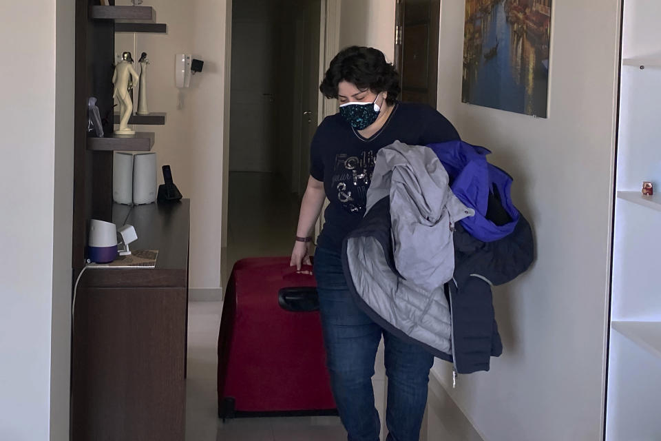 Pharmacist Rita El Khoury packs her belongings at her apartment in preparation for her move to France with her husband, in Dbayeh, north of Beirut, Lebanon, Saturday, May 8, 2021. Driven by financial ruin, collapsing institutions, hyperinflation and rapidly rising poverty, the 35-year-old pharmacist is among thousands of young and middle-aged professionals who have left or are leaving the country in the latest wave of Lebanese immigration. (AP Photo/Zeina Karam)