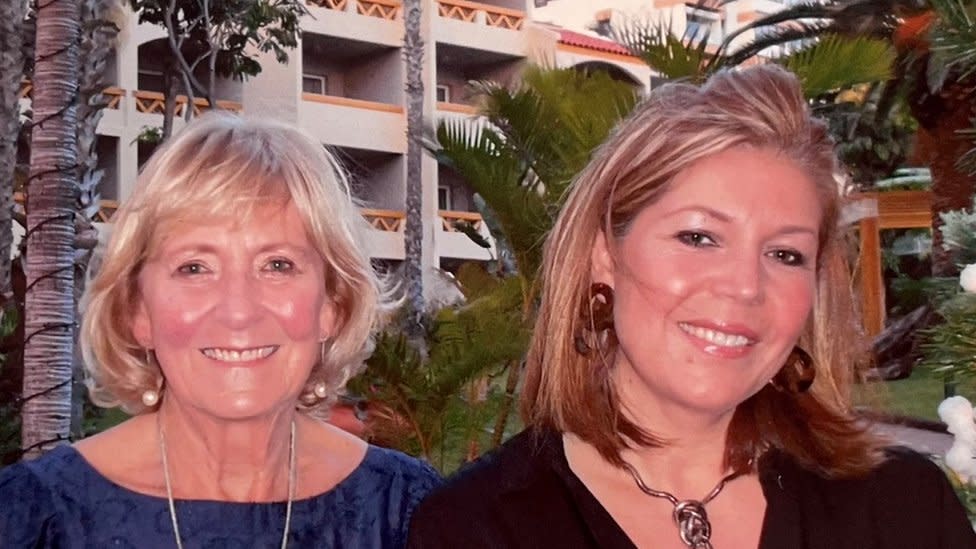 Rhiannon and Catherine on holiday standing together and smiling at the camera