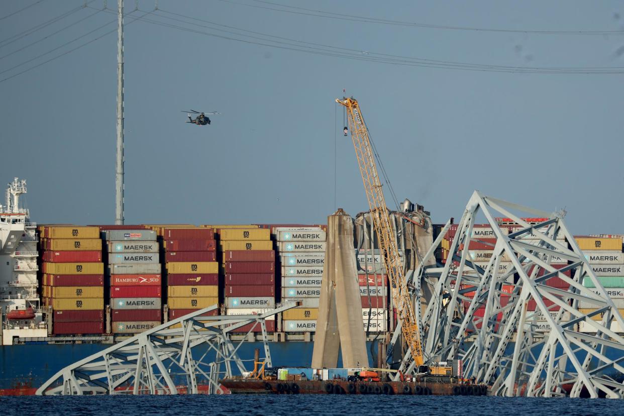 <span>A crane works on the debris of the Francis Scott Key Bridge in Baltimore, Maryland, on Friday.</span><span>Photograph: Kevin Dietsch/Getty Images</span>