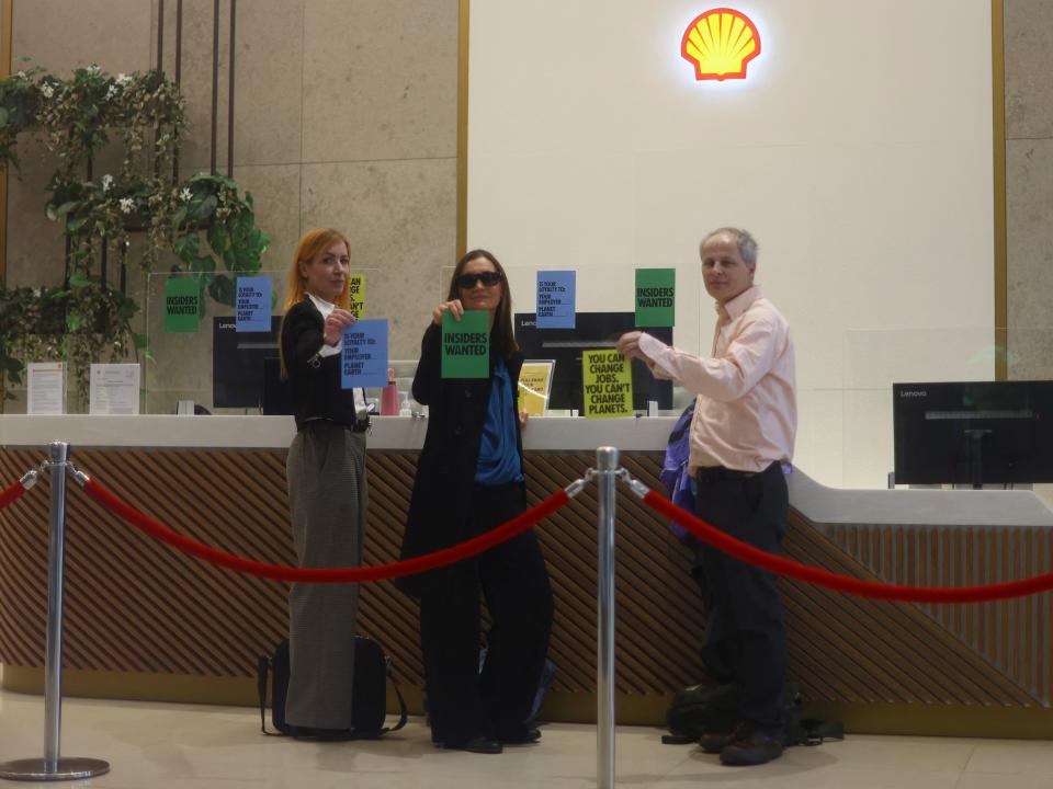 Activists from Extinction Rebellion glue themselves to the reception desk at Shell's headquarters (REUTERS)