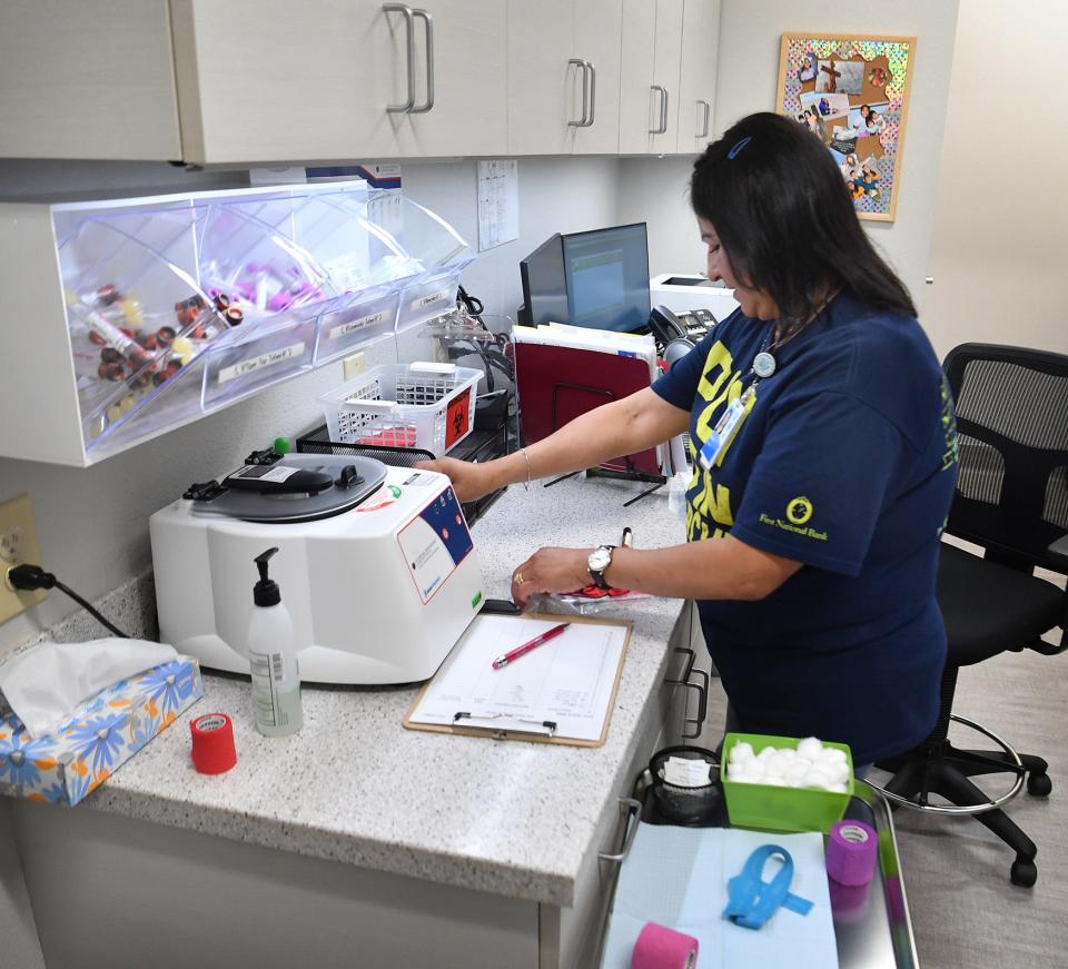 Patricia Ivey, a phlebotomist, works on blood samples in the lab at the Community Healthcare Clinic at Vernon College.