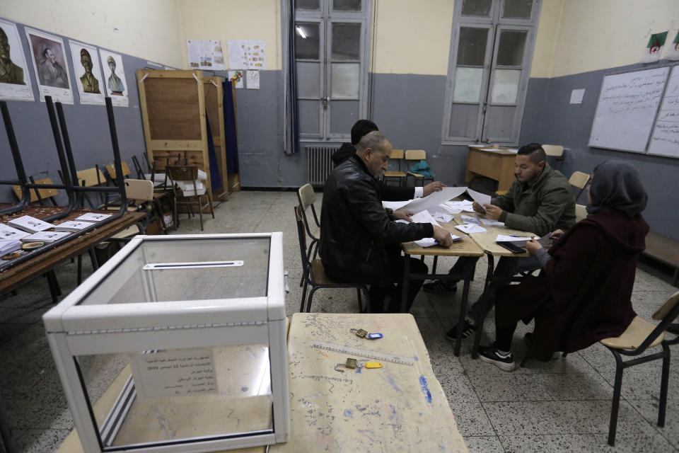 Polling station worker count ballots at a polling station Thursday Dec.12, 2019 in Algiers. Algerians — without a leader since April — voted for a new president or boycotted and held street protests against the elections decried by a massive pro-democracy movement that forced former leader Abdelaziz Bouteflika to resign. (AP Photo/Toufik Doudou)