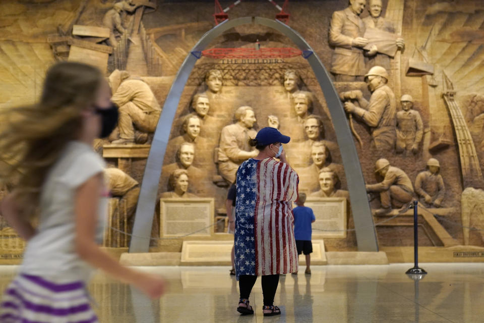 Visitors to the Gateway Arch tour the museum underneath the monument Friday, June 17, 2022, in St. Louis. Summer travel is underway across the globe, but a full recovery from two years of coronavirus could last as long as the pandemic itself. Interviews by The Associated Press in 11 countries this month show that the most passionate travelers are thronging to locales like the French Riviera, Amsterdam and the American Midwest. (AP Photo/Jeff Roberson)