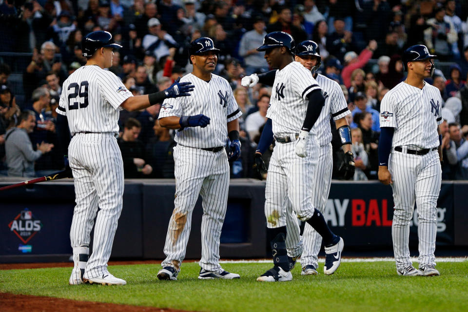 Oct 5, 2019; Bronx, NY, USA; New York Yankees shortstop Didi Gregorius (middle right) celebrates after hitting a grand slam with teammates against the Minnesota Twins in the third inning in game two of the 2019 ALDS playoff baseball series at Yankee Stadium. Mandatory Credit: Andy Marlin-USA TODAY Sports