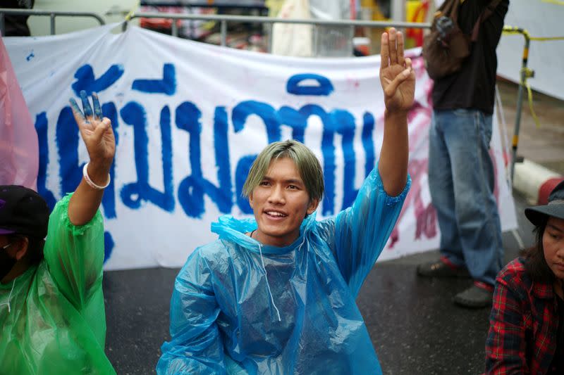 Pro-democracy protester Songphon "Yajai" Sonthirak does a three-finger salute during a mass rally in Bangkok